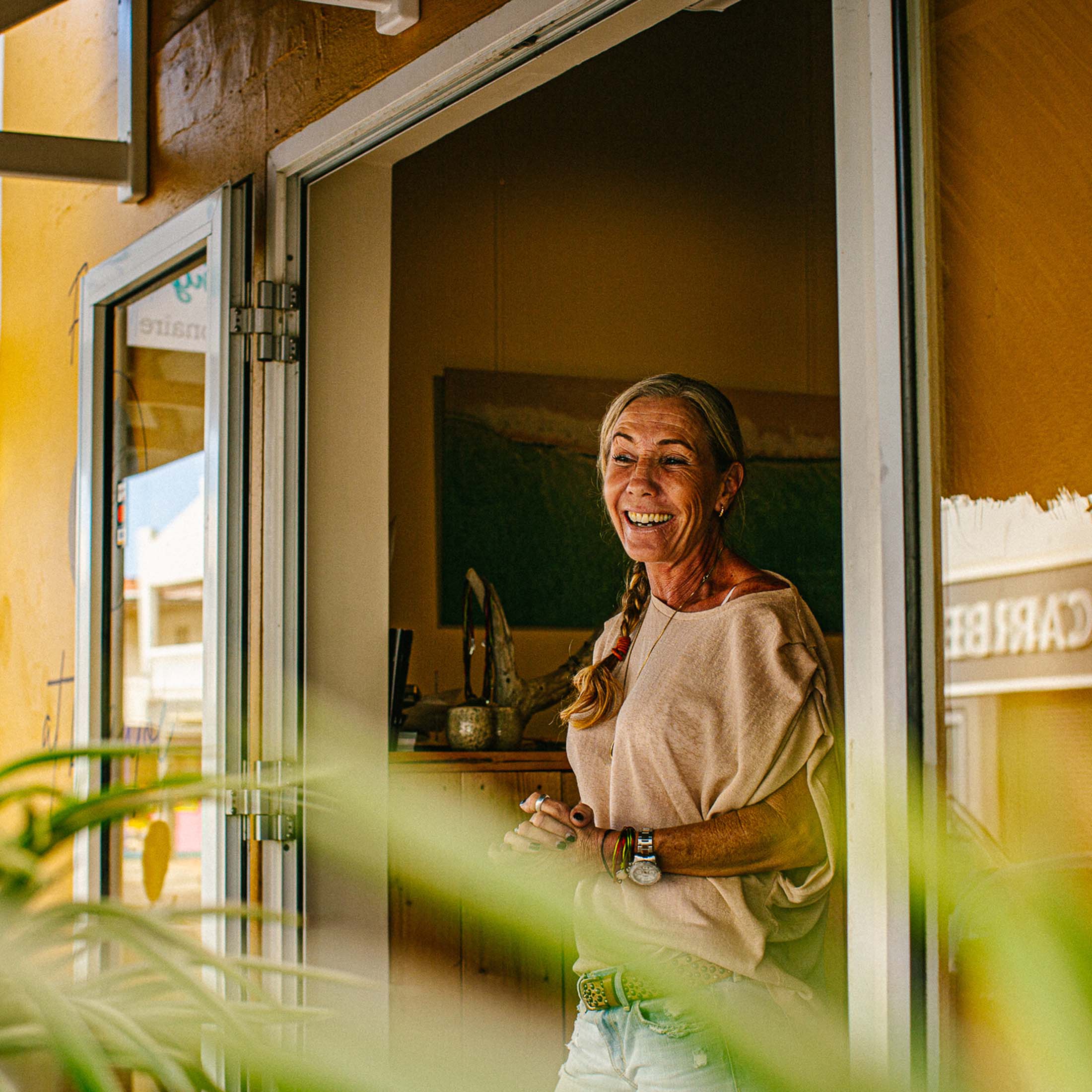 Woman looking out storefront door