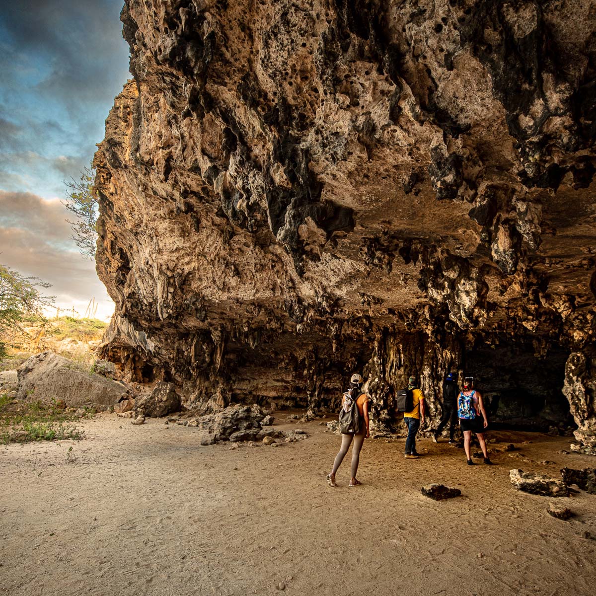 Group of people walking into an cave