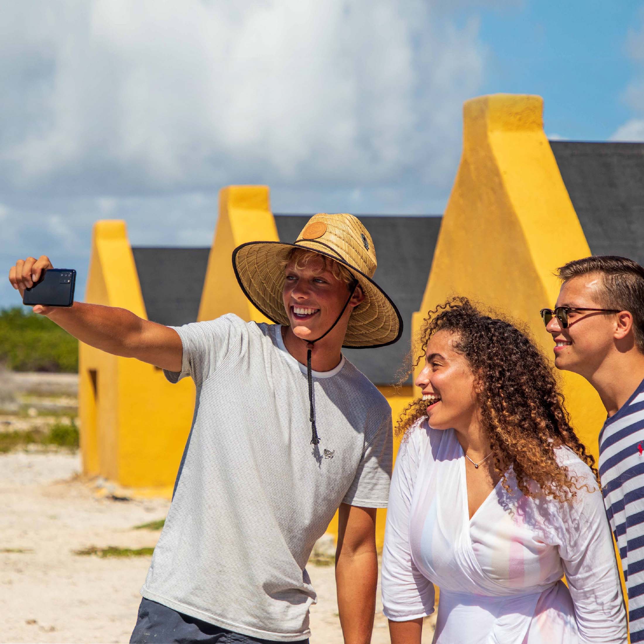 Group of friends taking selfie near historical site