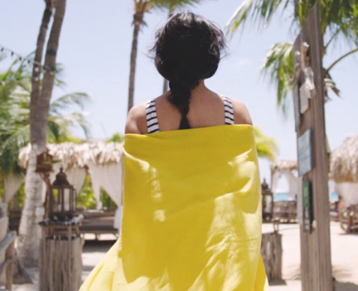 Woman walking in yellow coverup