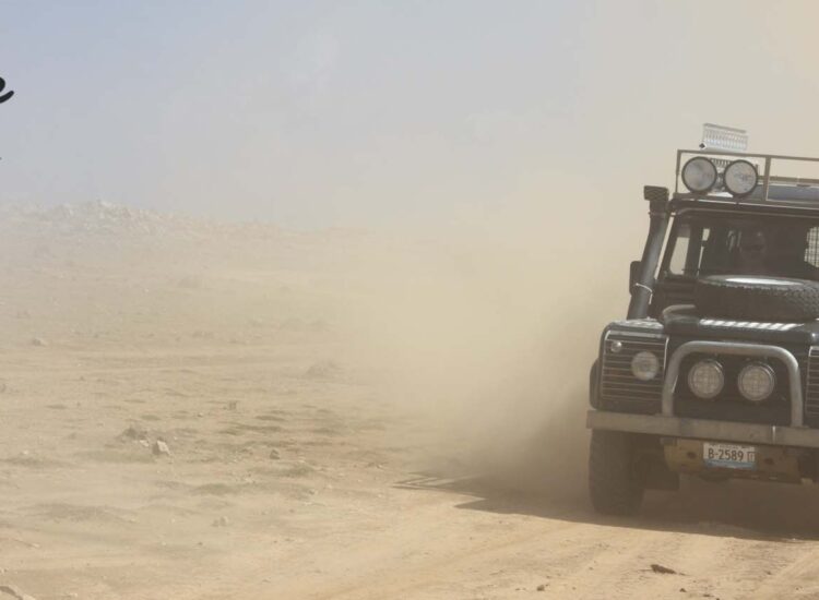 Safari truck driving on a dirt road