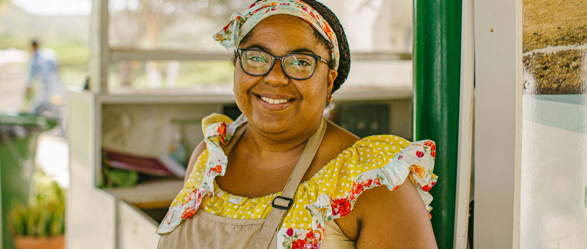 Woman in apron smiling at camera