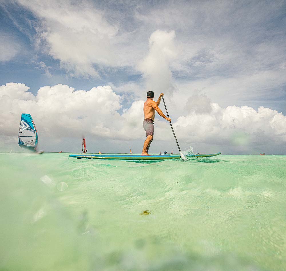 Man paddleboarding on water