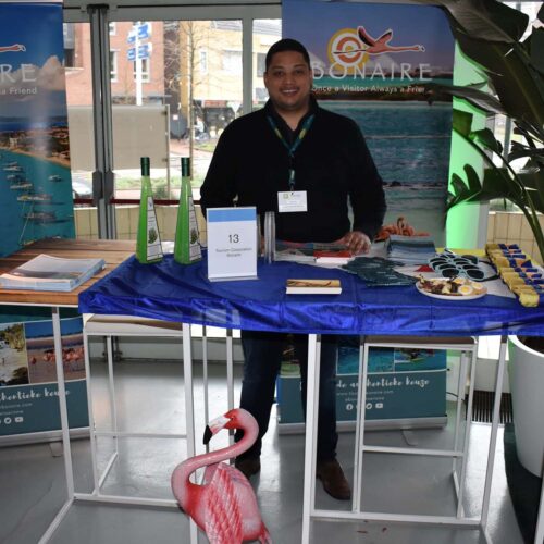 Man standing at the Tourism Corporation Bonaire event table