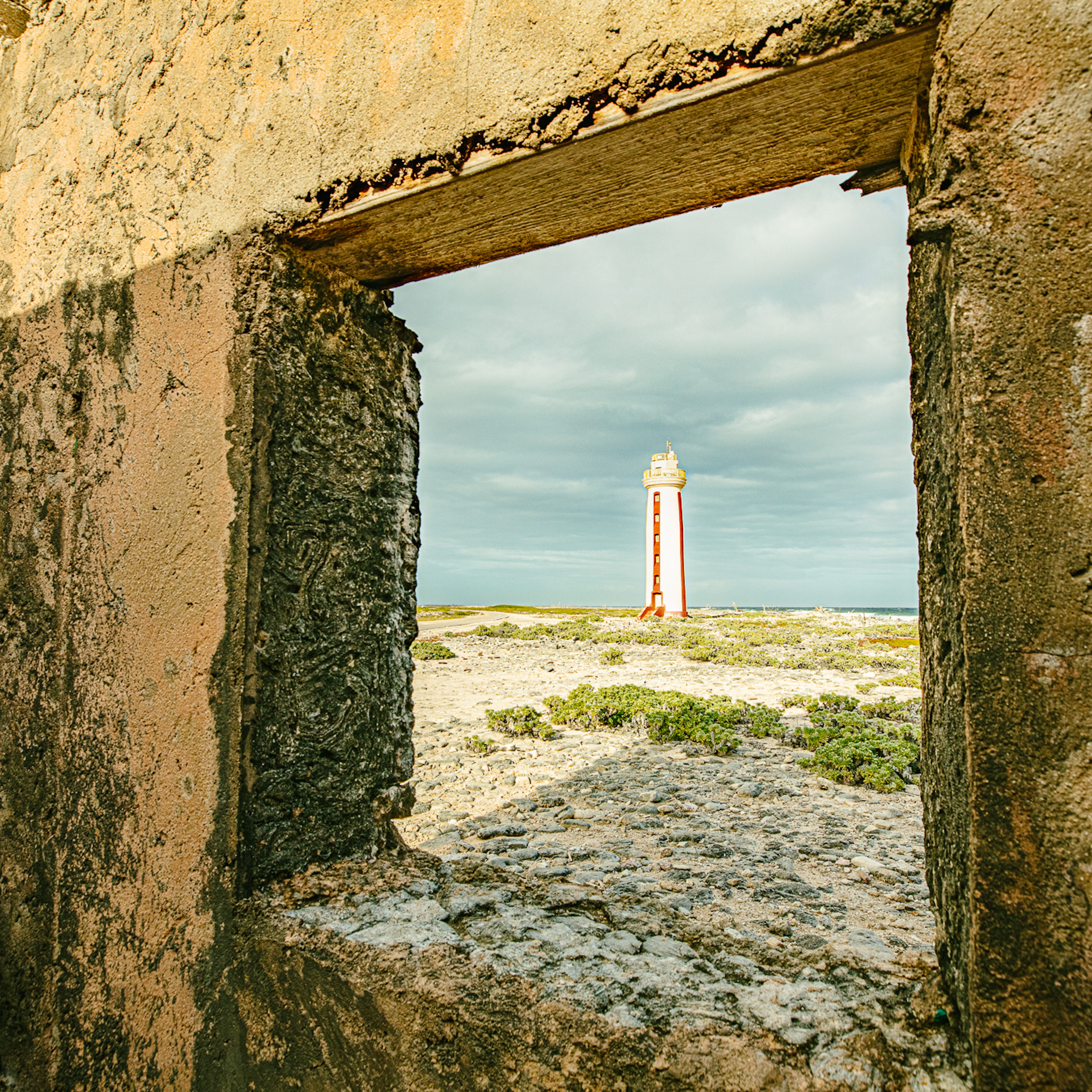 lighthouse seen through historical building's window